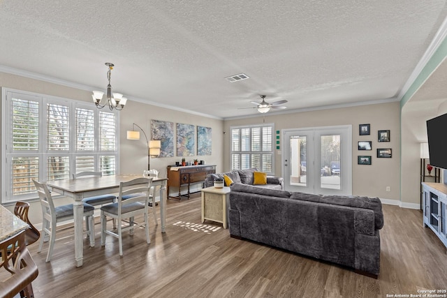 living room featuring crown molding, hardwood / wood-style floors, and a textured ceiling