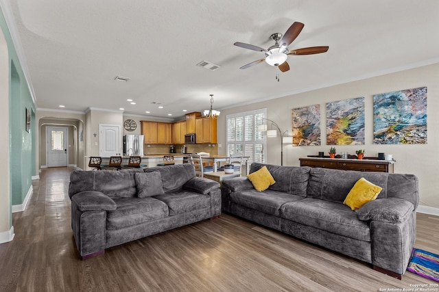 living room featuring crown molding, ceiling fan with notable chandelier, and light hardwood / wood-style floors