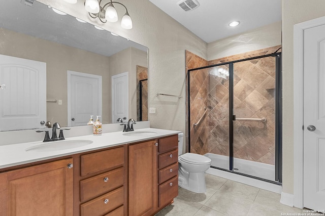 bathroom with vanity, tile patterned floors, a shower with door, and toilet