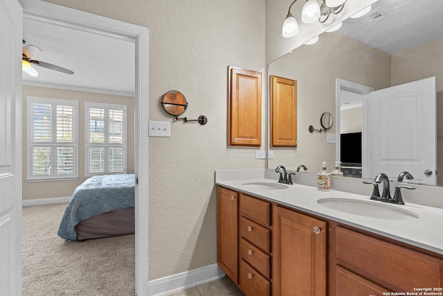 bathroom with vanity, ornamental molding, and ceiling fan