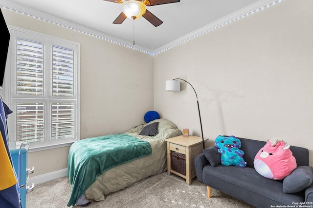 bedroom with ornamental molding, carpet flooring, and ceiling fan