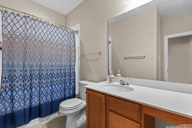 bathroom featuring vanity, toilet, and tile patterned flooring