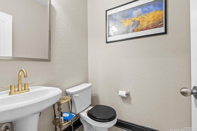 bathroom with toilet and sink