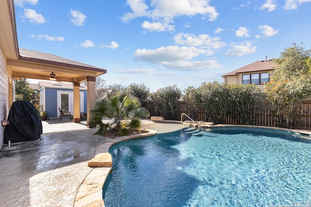 view of swimming pool with ceiling fan and a patio area