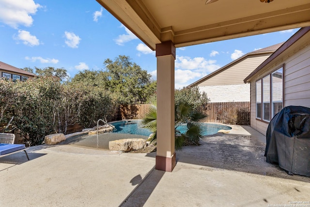 view of patio / terrace with ceiling fan, grilling area, and a fenced in pool