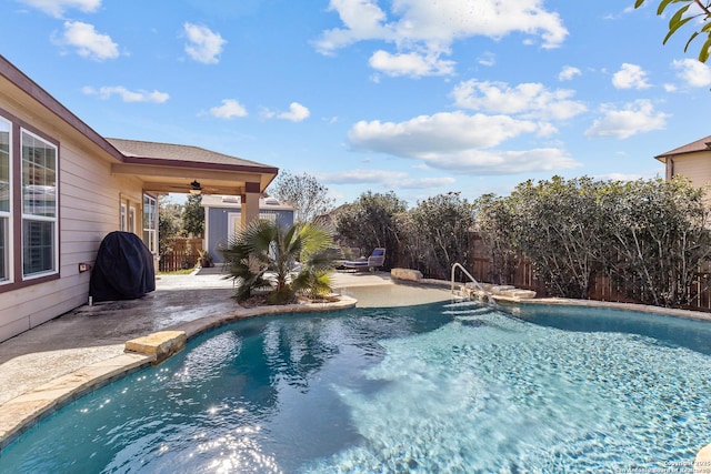 view of swimming pool with grilling area, a patio, and ceiling fan