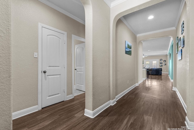 hall with ornamental molding and dark wood-type flooring