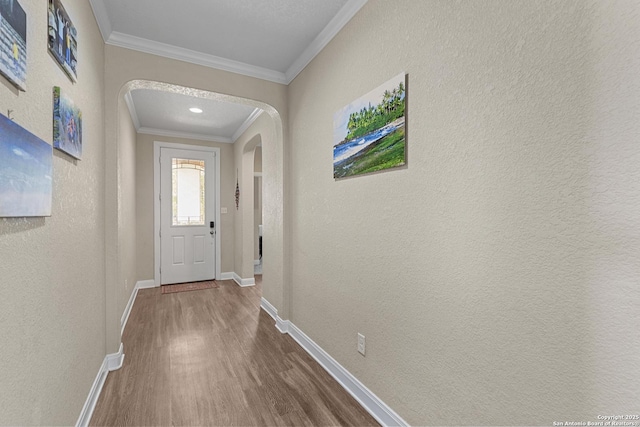 interior space with hardwood / wood-style floors and crown molding