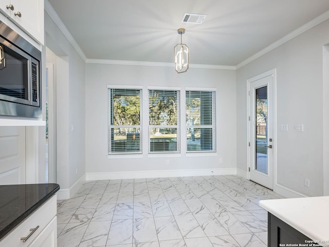 unfurnished dining area with ornamental molding