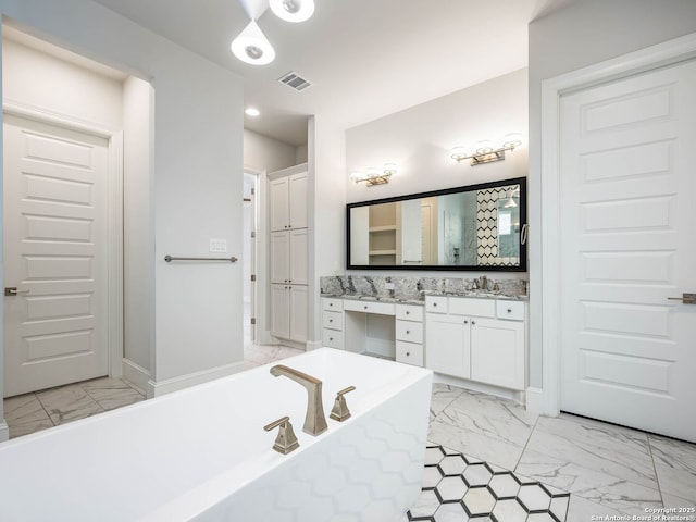 bathroom with vanity, a washtub, and decorative backsplash