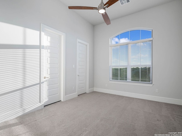 unfurnished bedroom featuring ceiling fan and light carpet