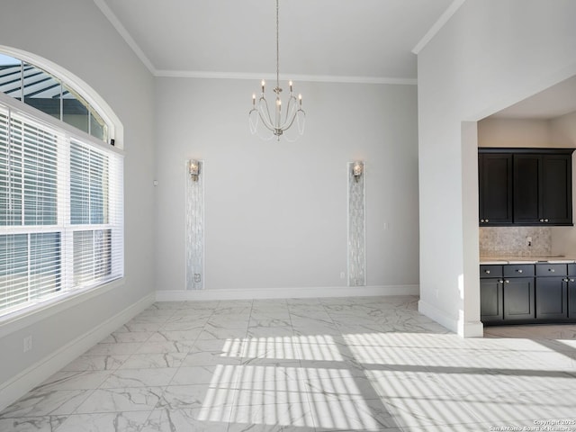 unfurnished dining area featuring crown molding and a chandelier