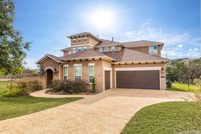 mediterranean / spanish house featuring a garage and a front lawn