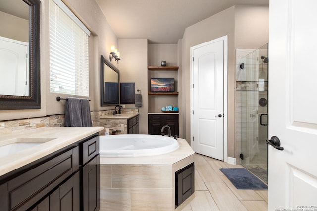 bathroom featuring vanity and shower with separate bathtub