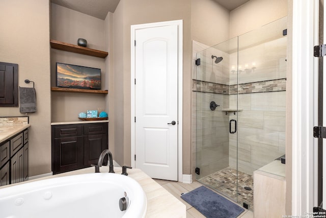 bathroom with vanity and independent shower and bath