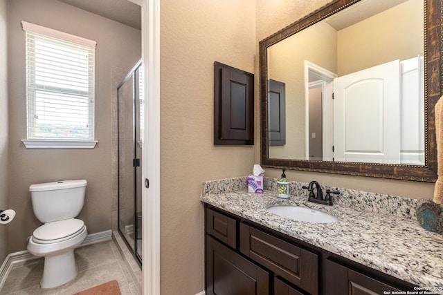 bathroom with an enclosed shower, vanity, plenty of natural light, and tile patterned floors