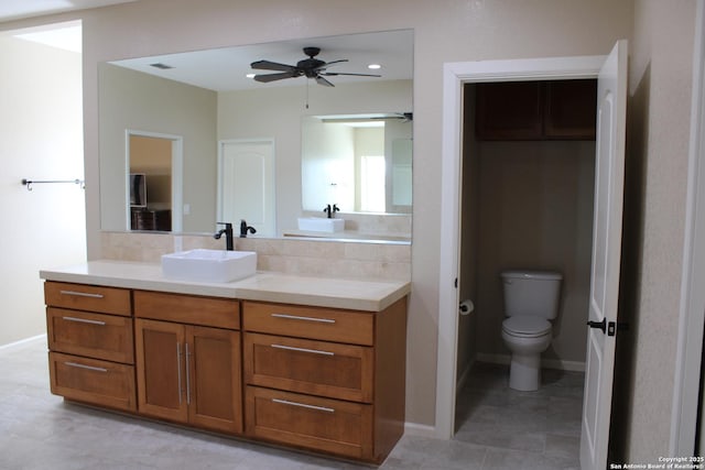 bathroom featuring vanity, ceiling fan, and toilet