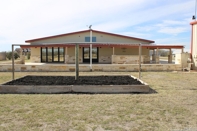 back of property with a yard and a patio