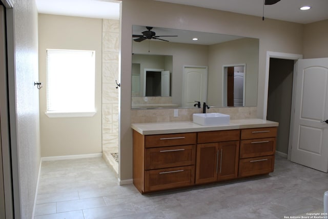 bathroom featuring walk in shower, ceiling fan, vanity, and backsplash