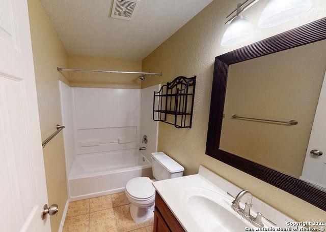 full bathroom with bathtub / shower combination, vanity, toilet, and a textured ceiling