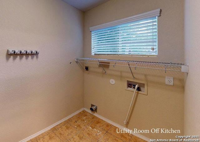 clothes washing area with electric dryer hookup, washer hookup, hookup for a gas dryer, and light tile patterned flooring