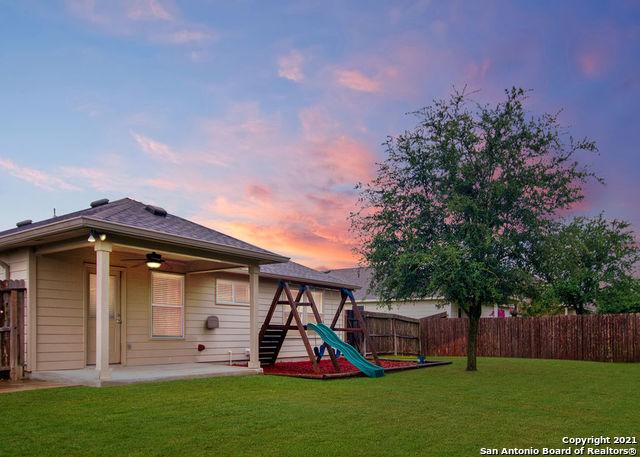 playground at dusk with a patio and a yard