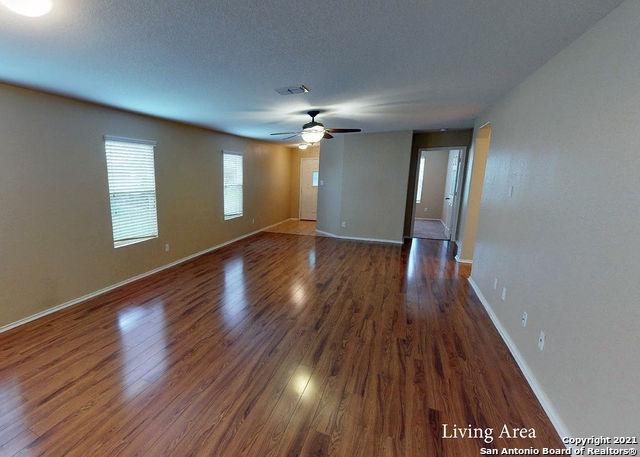 spare room with dark wood-type flooring, ceiling fan, and a textured ceiling