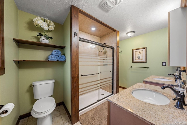 bathroom with tile patterned flooring, toilet, a textured ceiling, and walk in shower