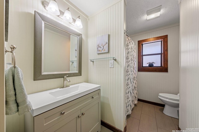 bathroom featuring a shower with shower curtain, vanity, a textured ceiling, tile patterned floors, and toilet