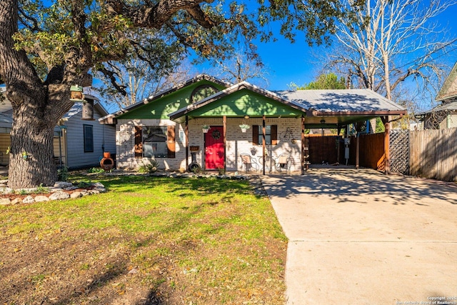 view of front of property with a carport and a front lawn