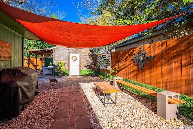 view of patio featuring grilling area and a storage shed