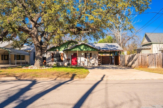 view of front of property with a carport and a front lawn