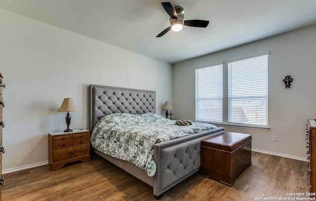 bedroom with wood-type flooring and ceiling fan