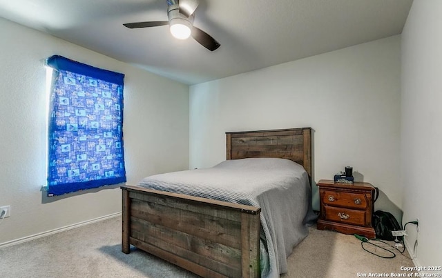 bedroom featuring light carpet and ceiling fan