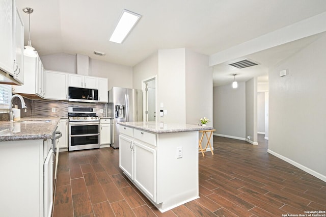 kitchen featuring visible vents, wood tiled floor, appliances with stainless steel finishes, and a sink