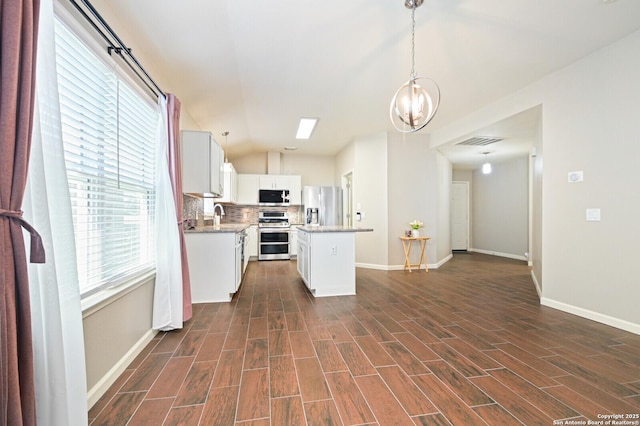 kitchen featuring visible vents, dark wood-style floors, appliances with stainless steel finishes, light countertops, and backsplash