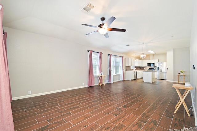 unfurnished living room with baseboards, visible vents, a ceiling fan, lofted ceiling, and dark wood-style floors