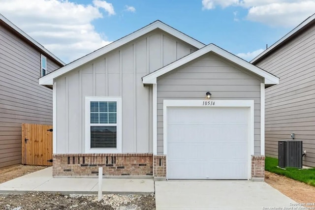 view of front of property with a garage and cooling unit