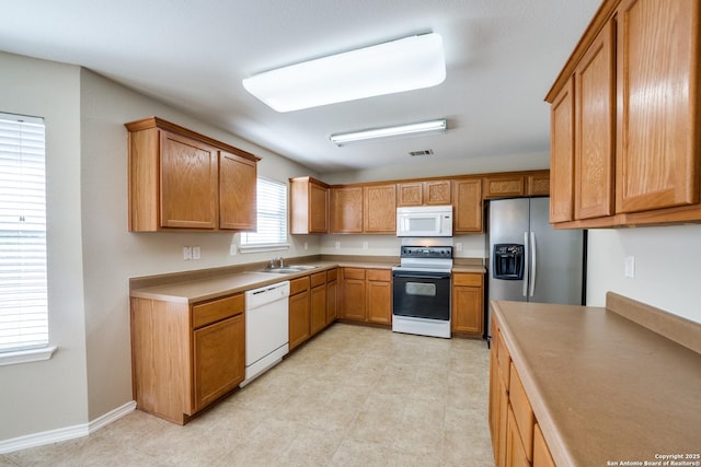 kitchen with white appliances and sink