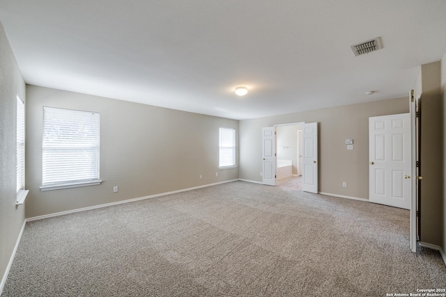 empty room featuring light carpet