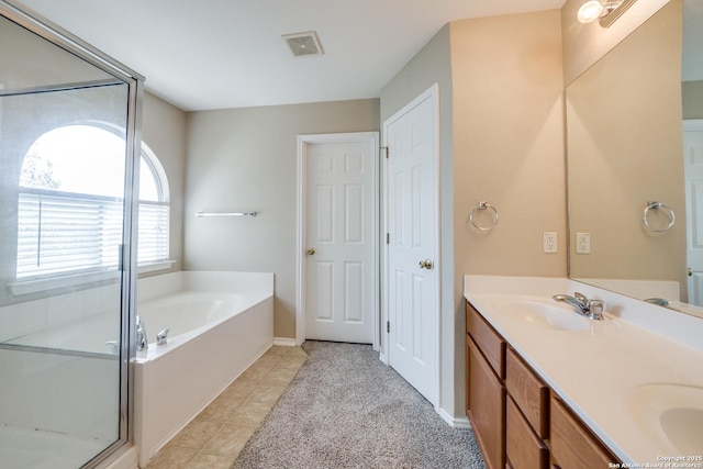 bathroom with vanity, tile patterned floors, and shower with separate bathtub