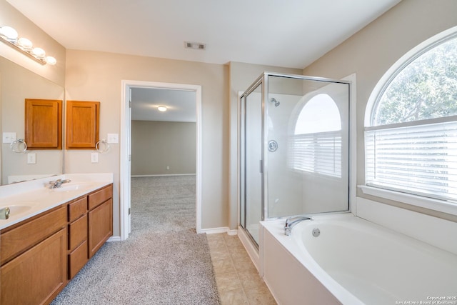 bathroom featuring tile patterned floors, separate shower and tub, and vanity