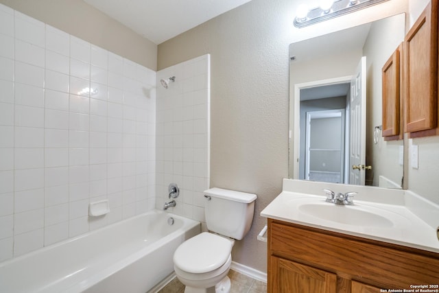 full bathroom with vanity, tiled shower / bath combo, and toilet