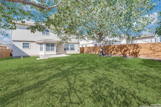 rear view of property featuring a patio area and a lawn