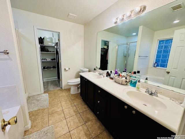 full bathroom featuring tile patterned flooring, plus walk in shower, vanity, and toilet