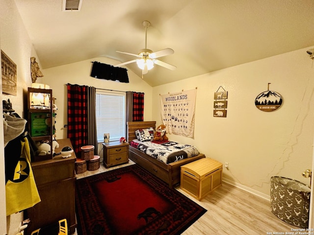 bedroom featuring lofted ceiling, ceiling fan, and light wood-type flooring