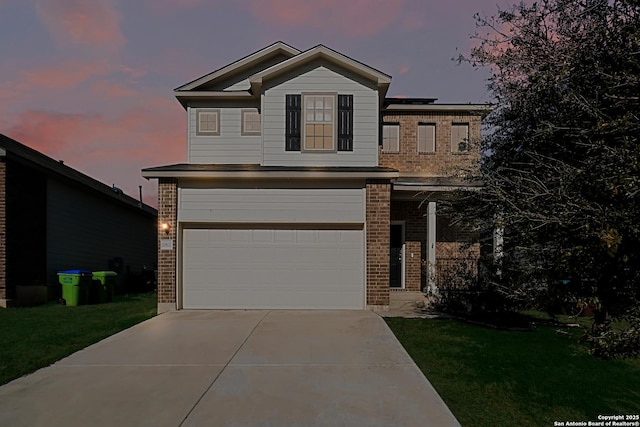 view of front of home featuring a garage and a lawn