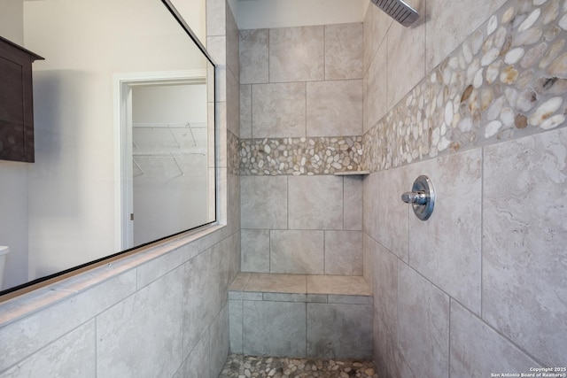 bathroom with a tile shower