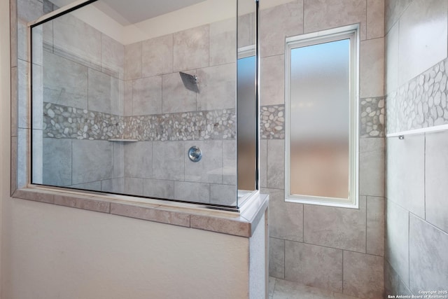 bathroom with tiled shower