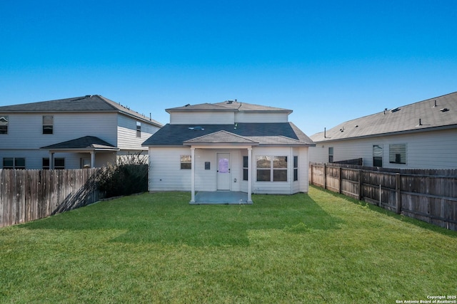 back of property featuring a patio area and a lawn